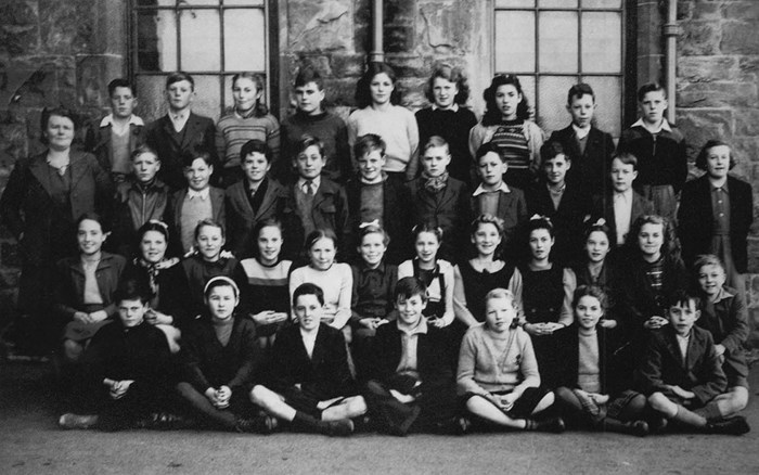 A group of 11-year-old schoolchildren on the first year they took the test. Our participant, John Scott, is in the centre of the front row.