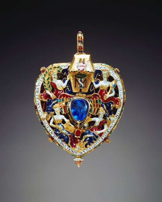 Sparkling golden heart-shaped jewel with blue central gemstone, crowned topless figures and writing along the edges.
