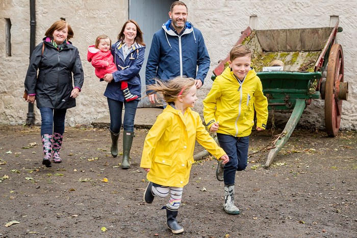 A family of 6 wearing wellies and waterproofs