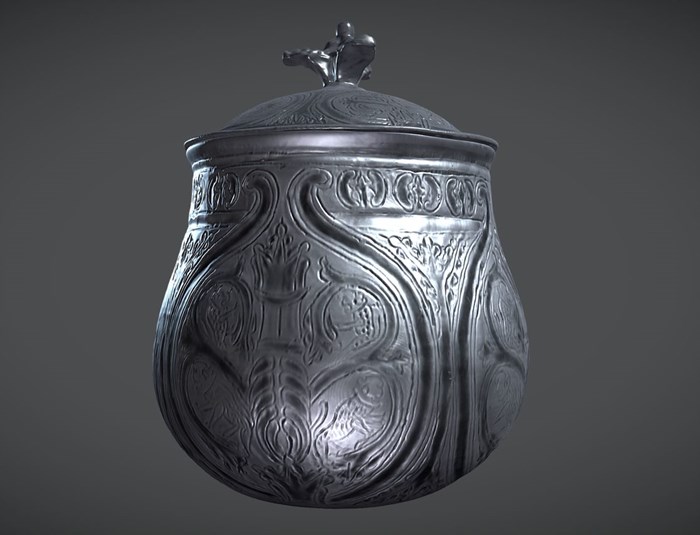 3D scanned vessel against a grey background. The vessel is smooth, shiny and intricately decorated all over with swirling, naturalistic patterns. A carving of a crown-shaped fire temple is the focus.