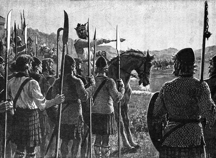 19th century woodcut depicting King Robert the Bruce, mounted on a horse, giving a speech to his soldiers and pointing an axe at unseen enemies across a battlefield.