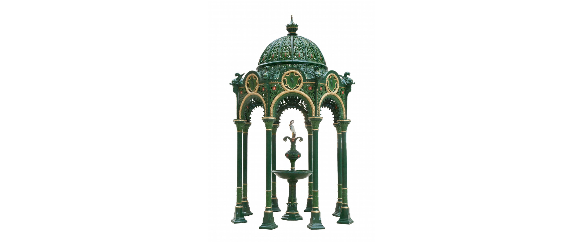 Drinking fountain with intricate details cast in green and gold colours.