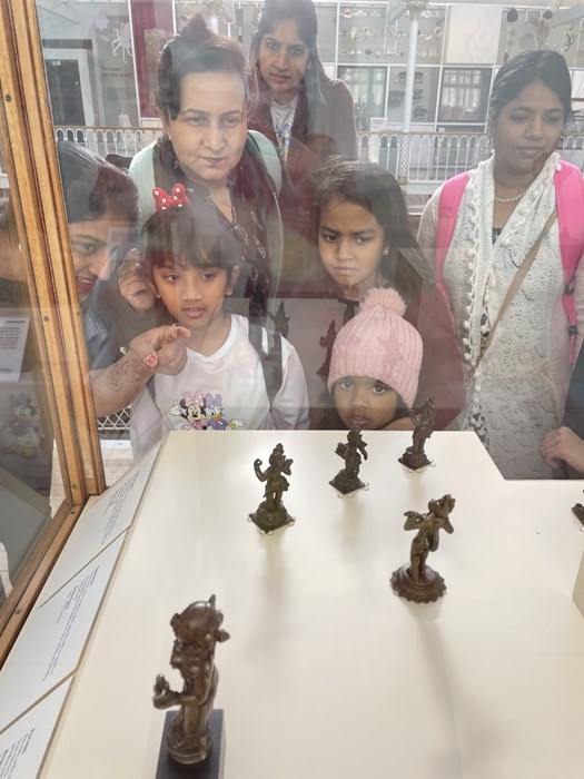 NKS members encounter small statues of various deities, including Krishna.