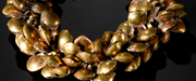 Anklet of gilded copper pellet bells, threaded onto string.