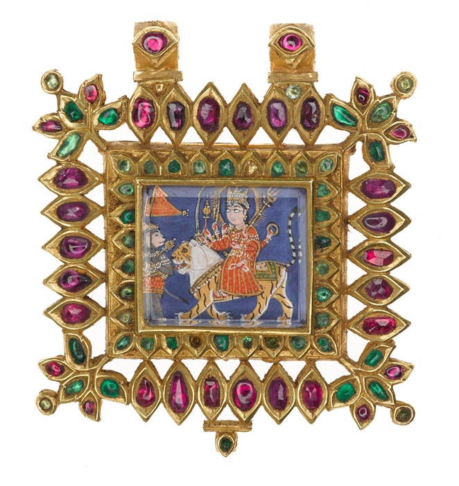 Pendant of gold inlaid with rubies and emeralds, beneath the central rock crystal a depiction of the Hindu goddess Durga, preceded by Hanuman.
