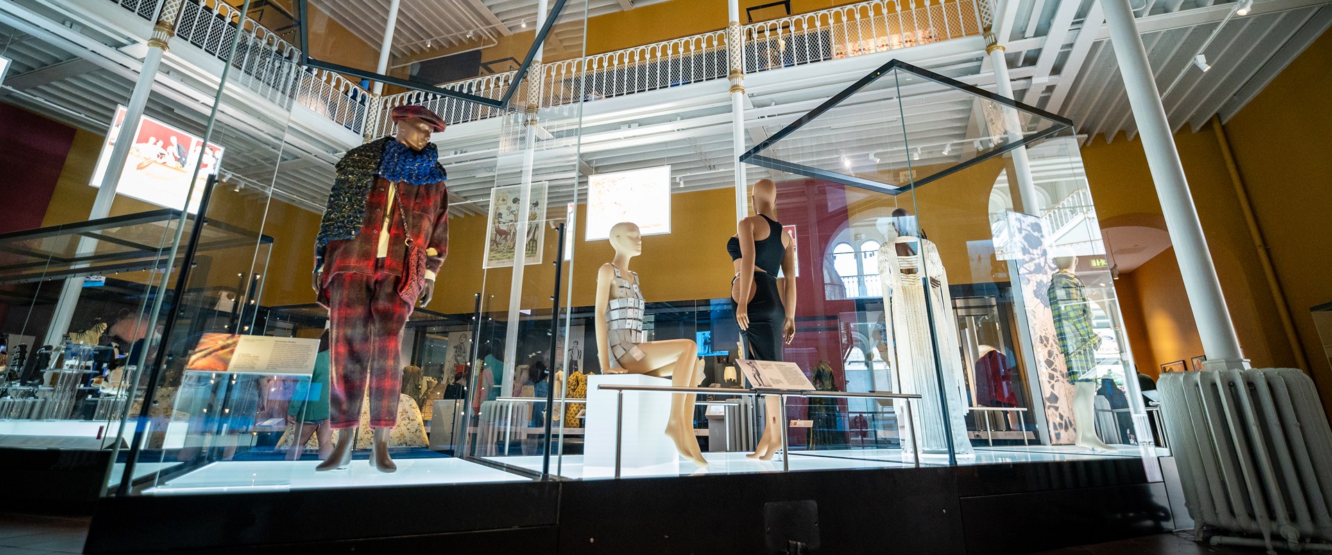 Five mannequins stand on a runway in our Fashion and Style Galleries featuring looks from designers.