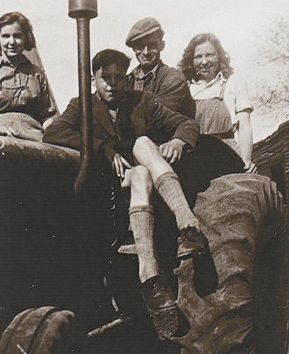Landgirl with group on Fordoson tractor 1946