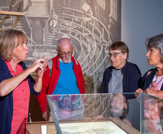 A group of visitors on a BSL tour of an exhibition space