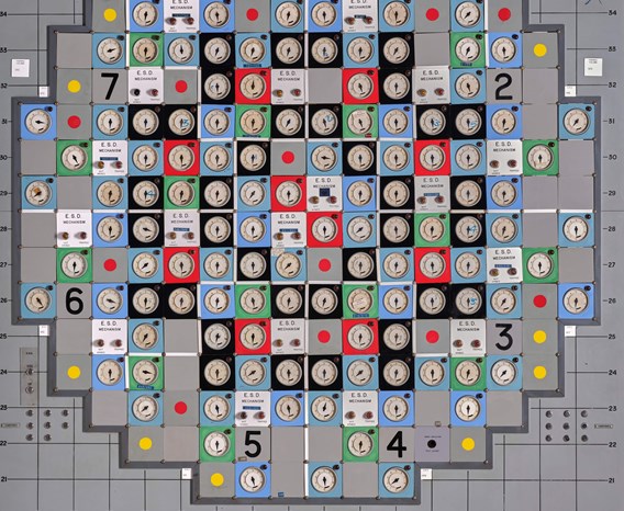 The Hunterston nuclear power station panel, showing lots of dials on red, blue, green and black squares on a grey machine.