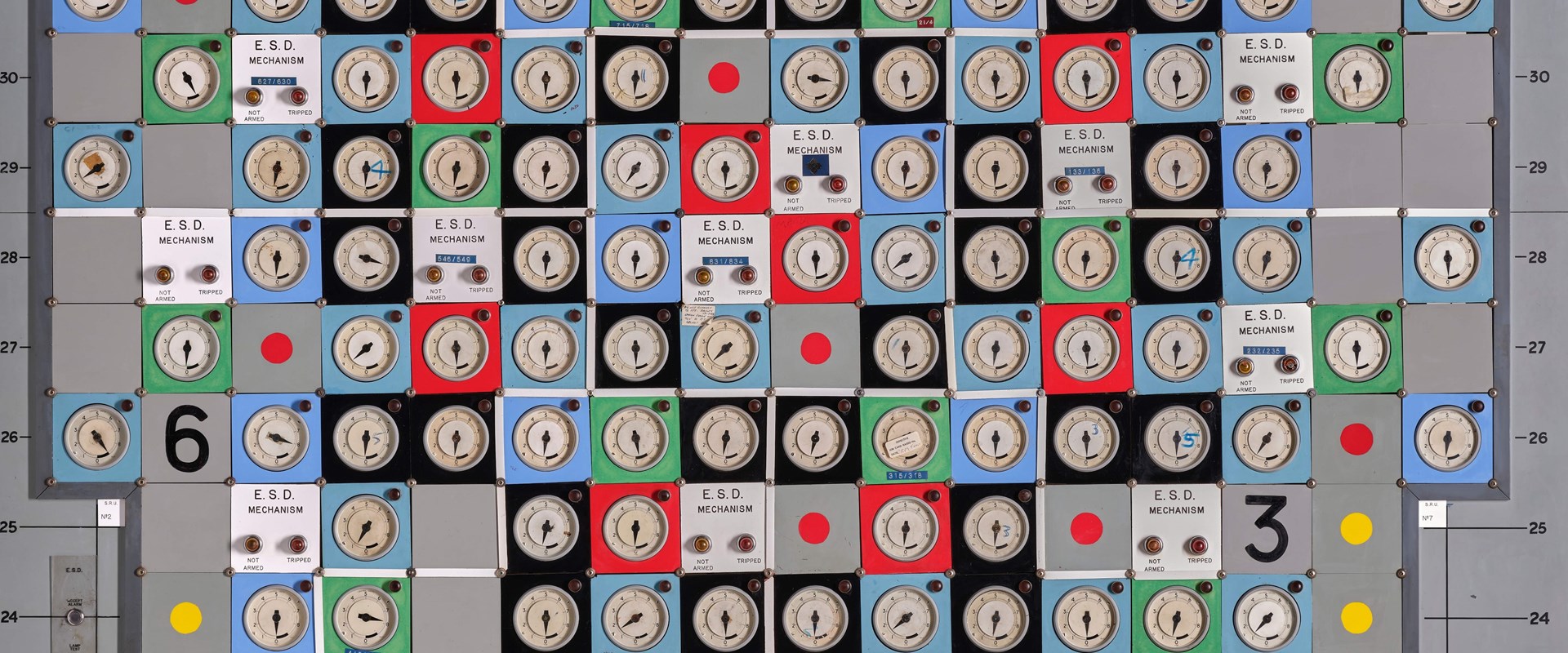 The Hunterston nuclear power station panel, showing lots of dials on red, blue, green and black squares on a grey machine.